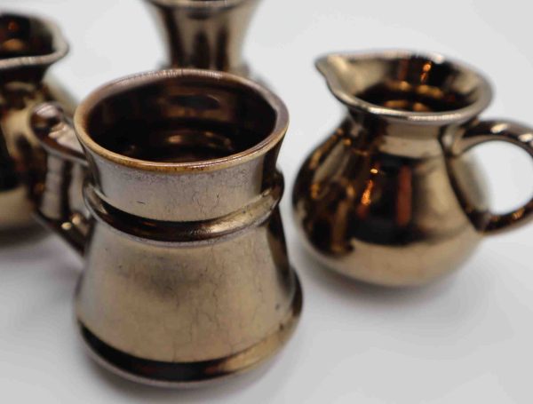 Gold coloured Prinknash Jugs